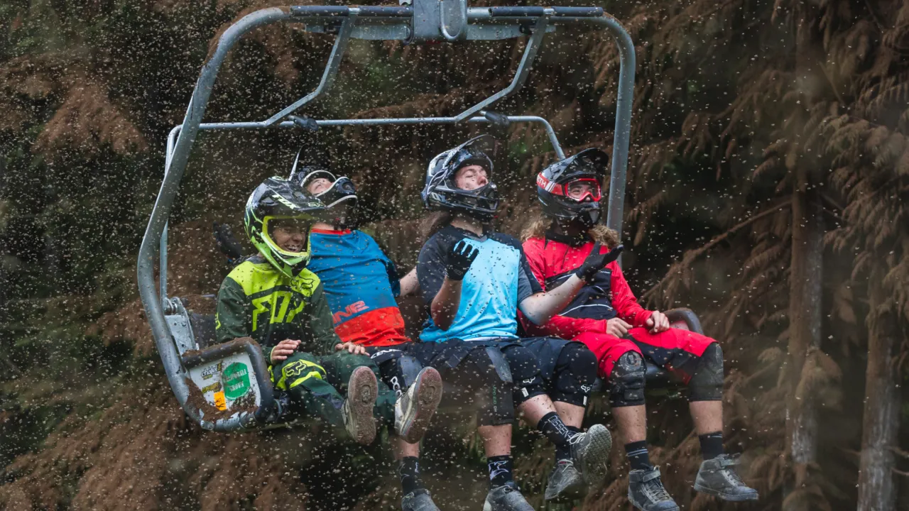 Mountain Bikers ride the chairlift during an unReal Dirt Blizzard.