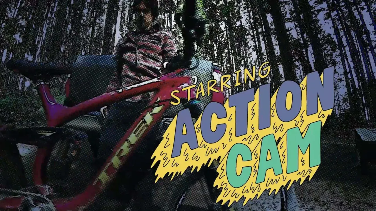 Cam McCaul holds a bike in a pixelated image that says Action Cam in super hero style writing.
