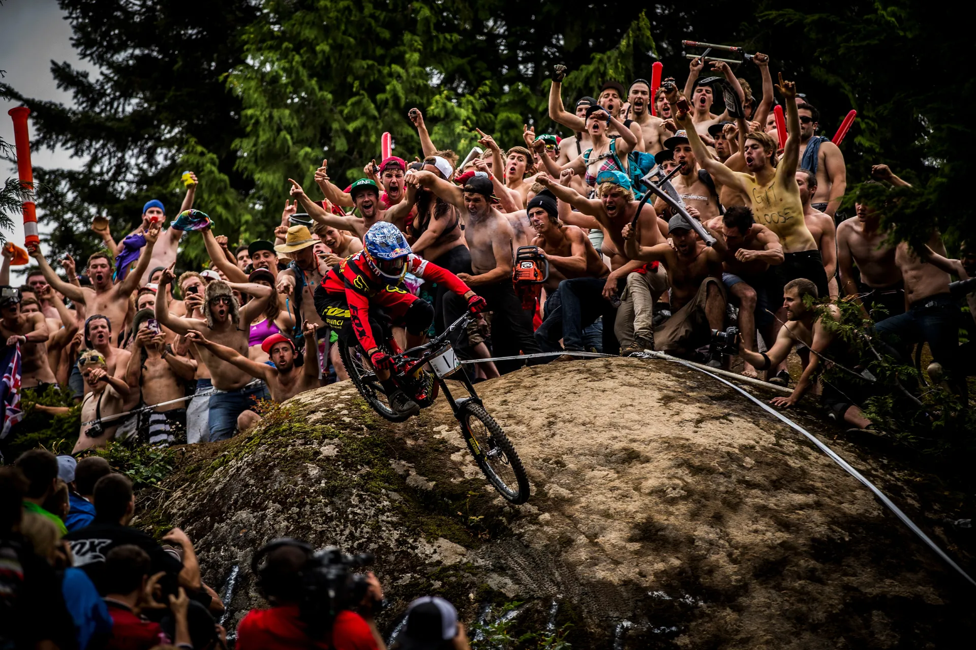 Downhill mountain bike legend Stevie Smith descends the infamous Heckler's Rock in Whistler BC surrounded by hundreds of cheering fans.