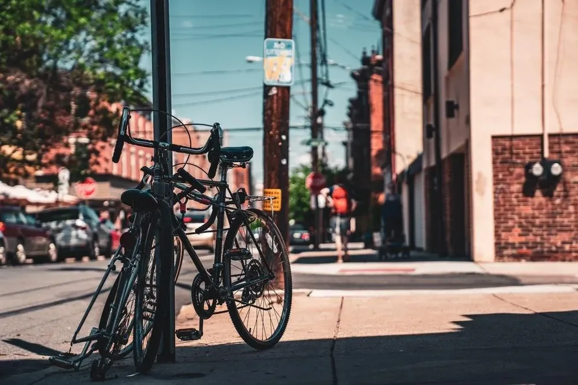 Bike parked and locked against a signpost